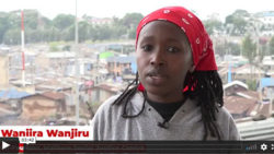 wanjira wanjiru talking to camera with a town in the background