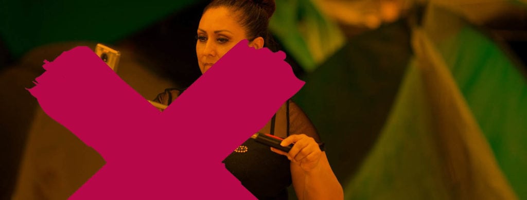 Missing Voices logo with a womanstanding behind on a laptop