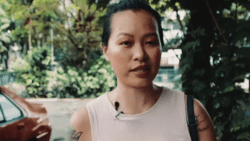 Activist Victoria Cheng with trees and a car in the background